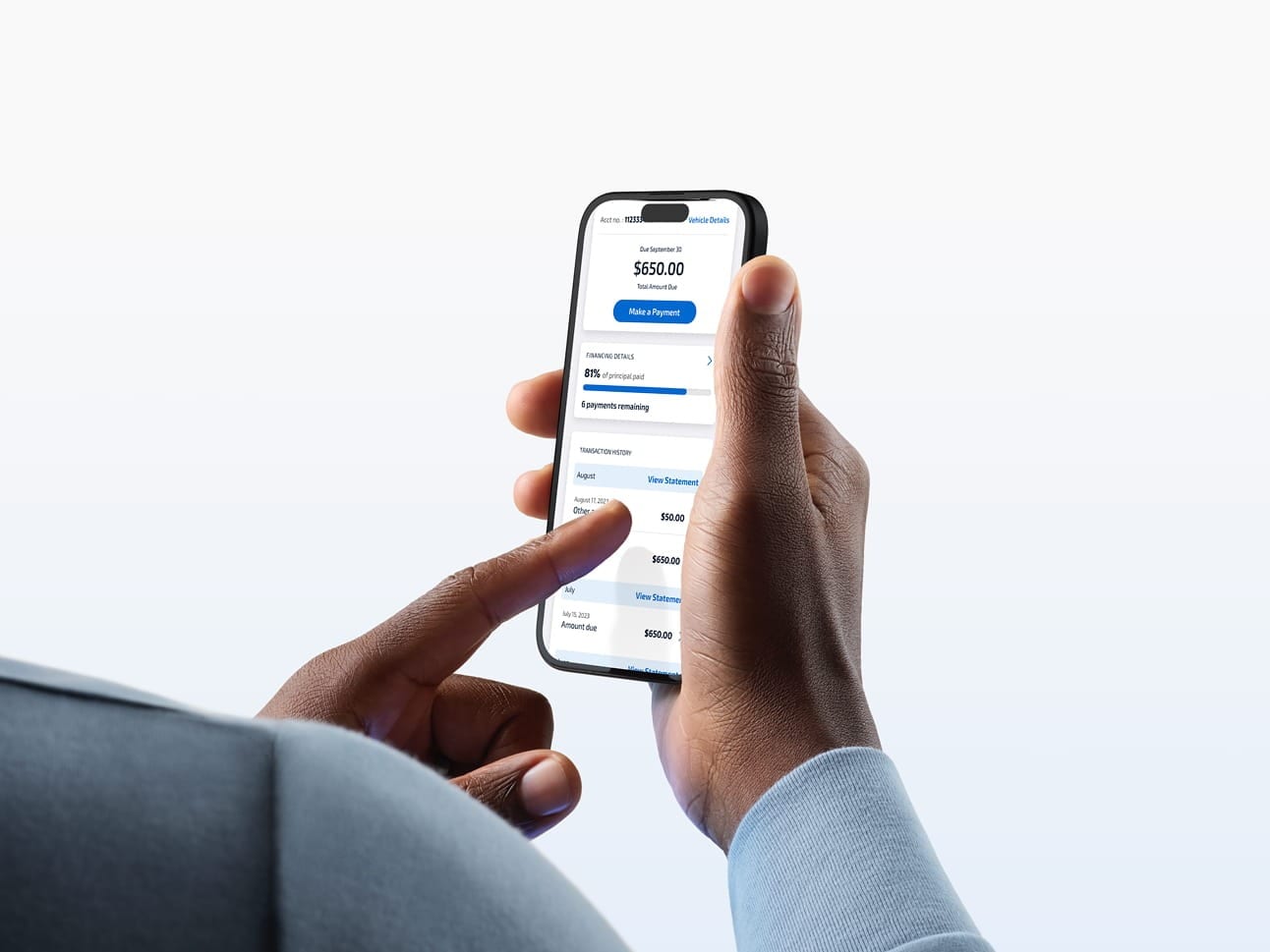 A man using his smartphone to make a Ford Credit payment. 