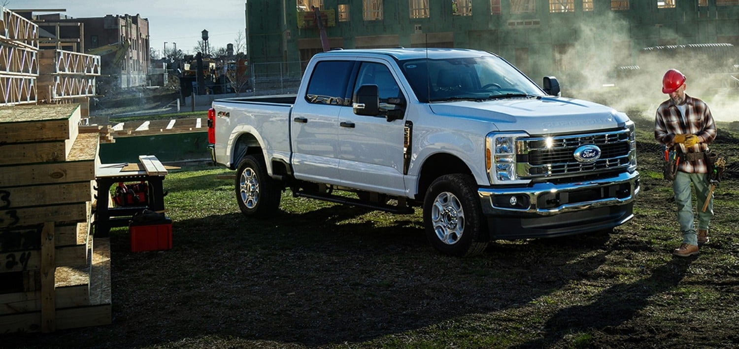 White Ford pickup truck parked outdoors with overlaid text reading, “Employee Pricing. You Pay What We Pay.”
