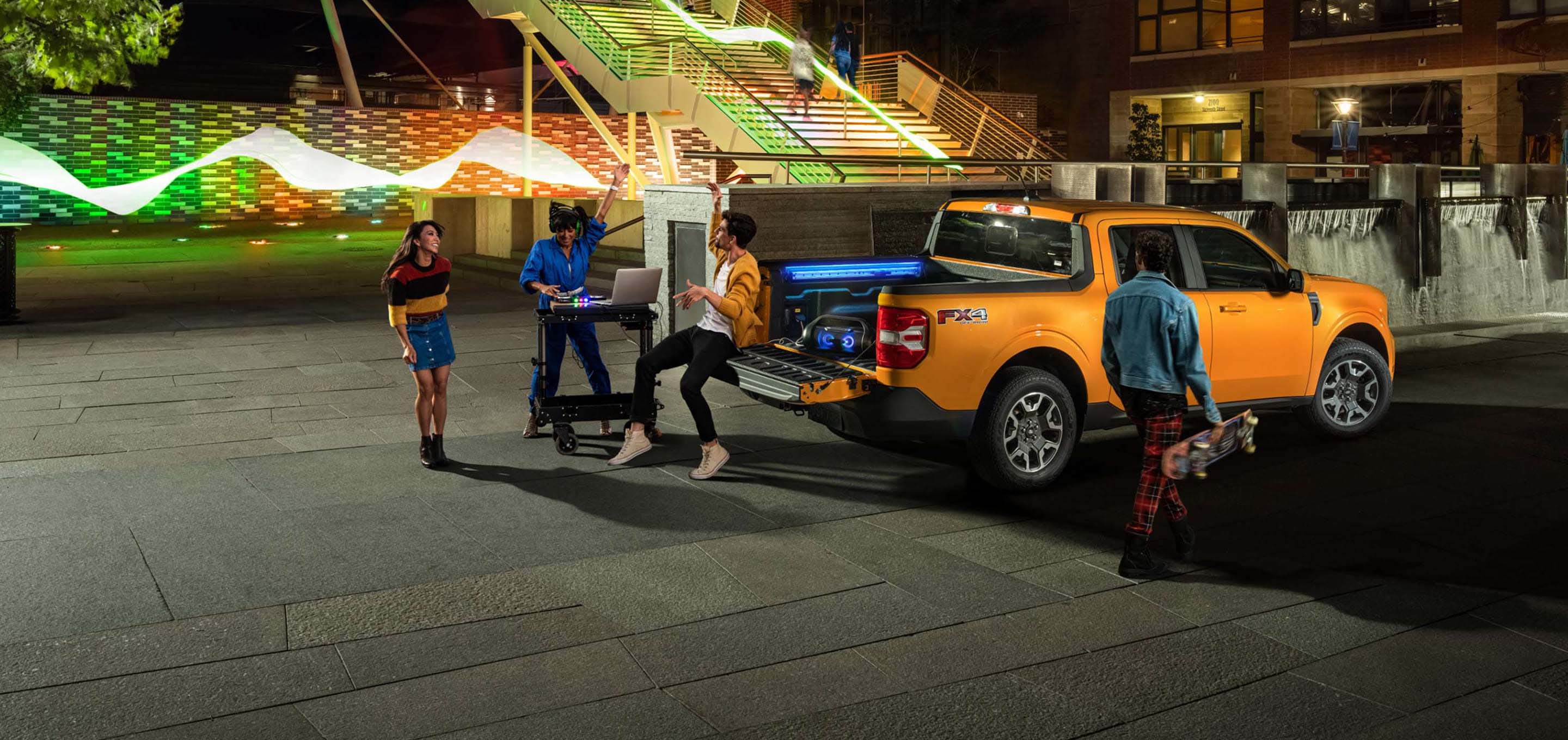 Ford pickup truck parked at night in a lively plaza