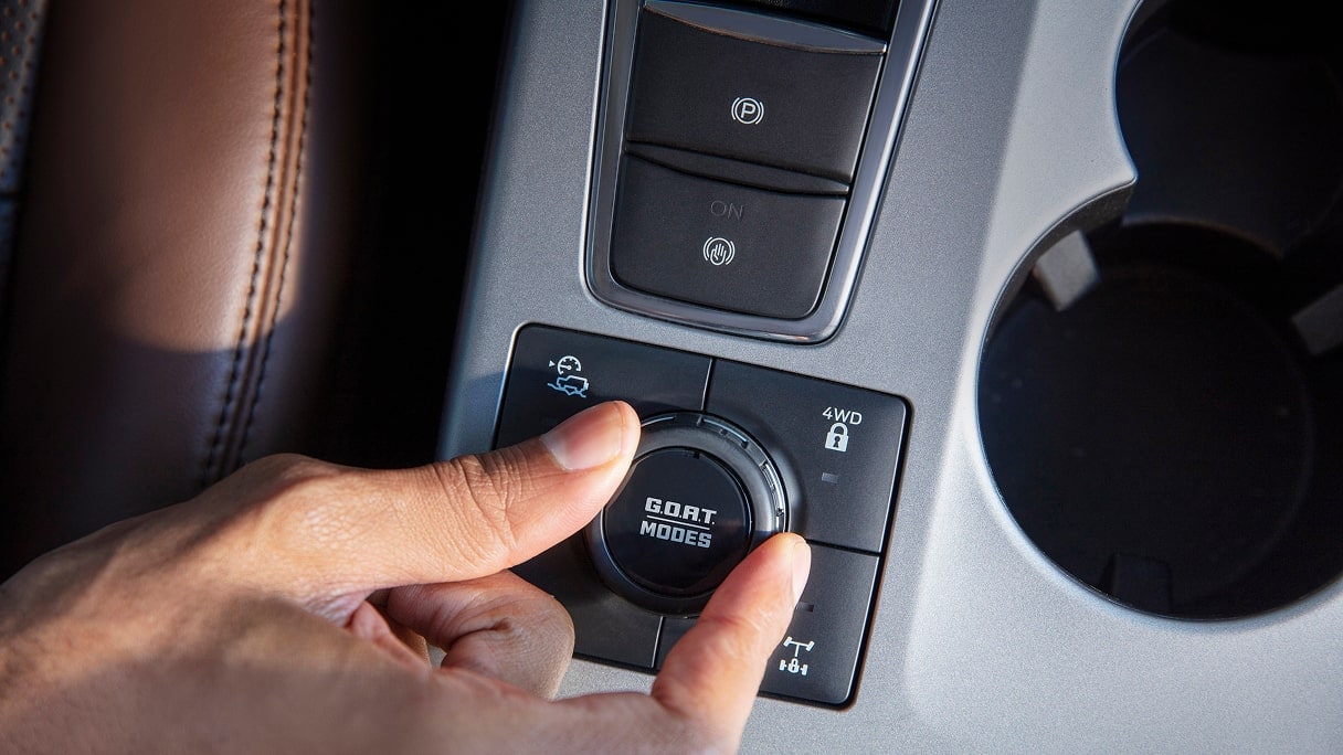 A driver selecting the drive mode inside a Ford vehicle.  