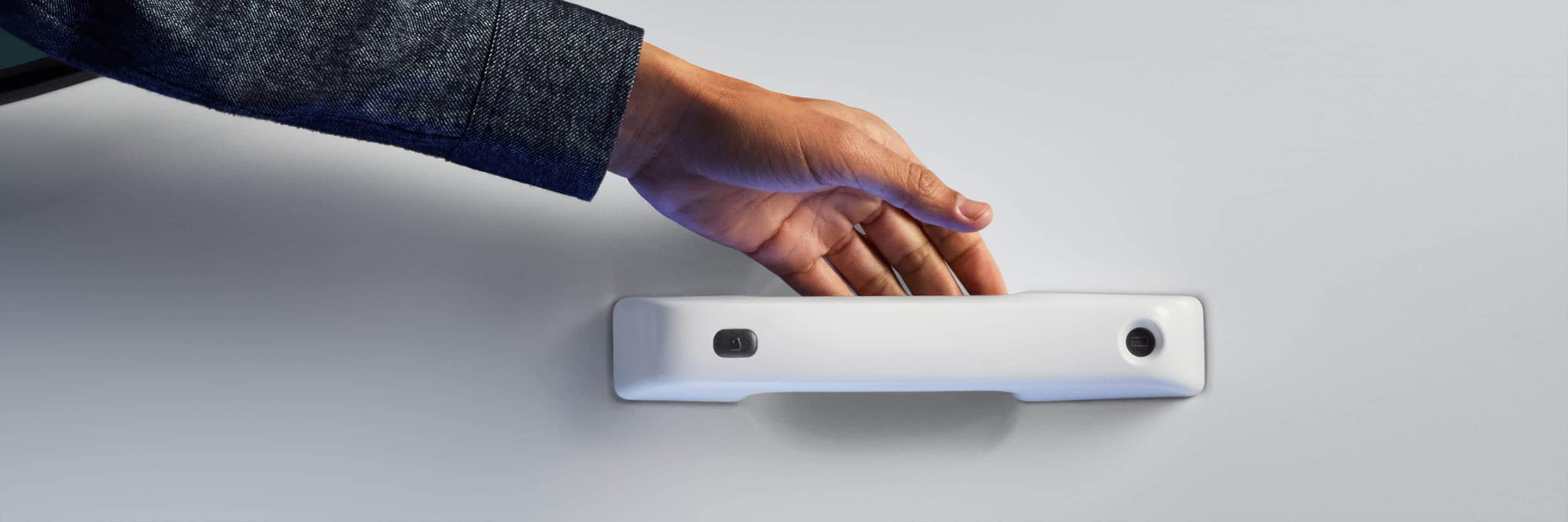 A person’s hand reaching for a vehicle door handle.