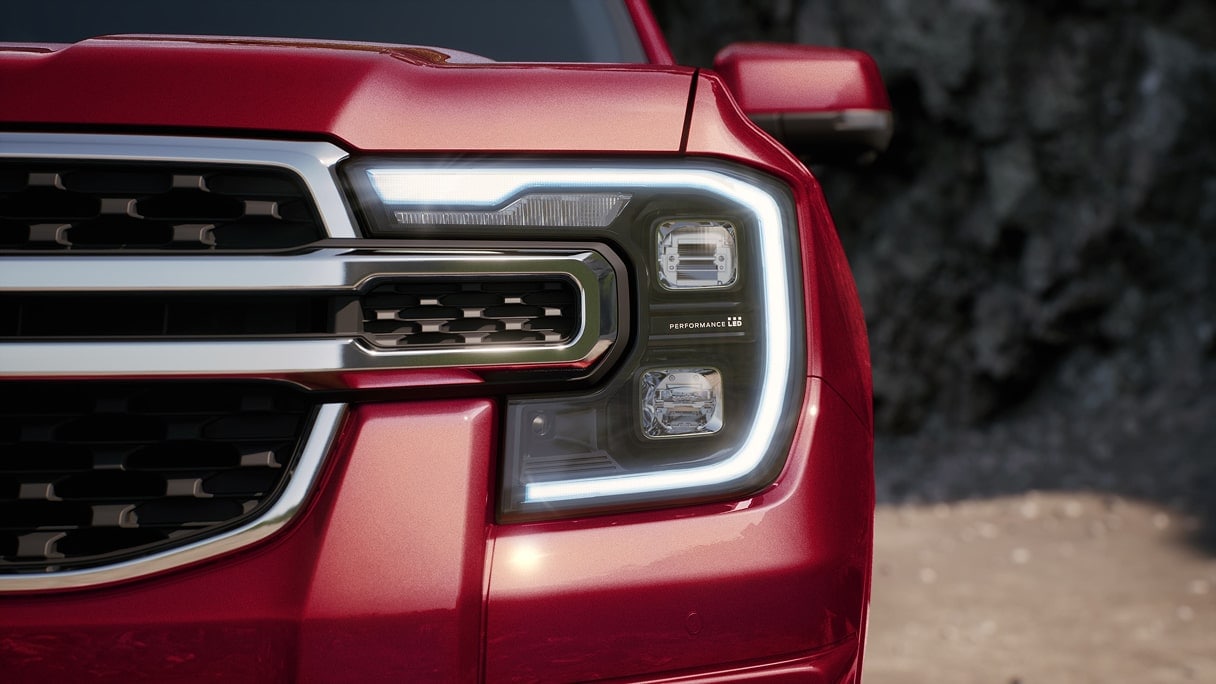 The headlight of a Ford pickup truck.