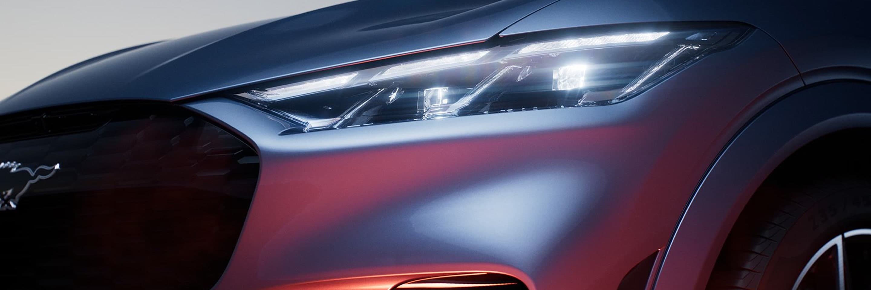 Ford Mustang Mach-E headlight and grille close up.