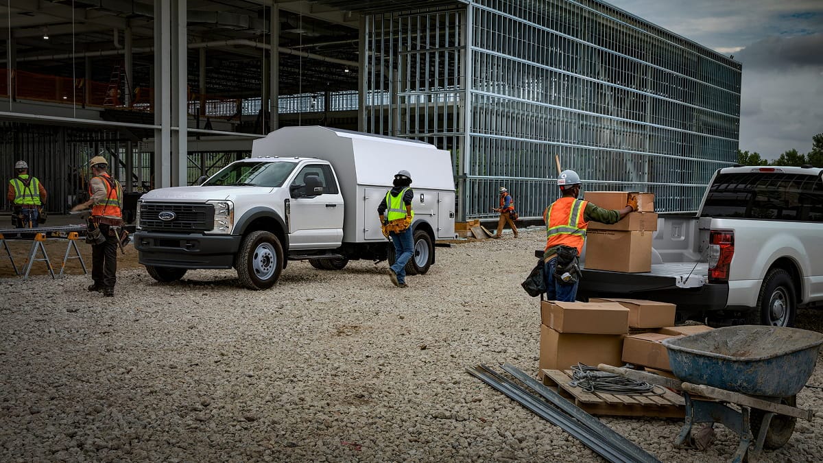 Construction crew working at a job site with their Ford F-Series trucks. 