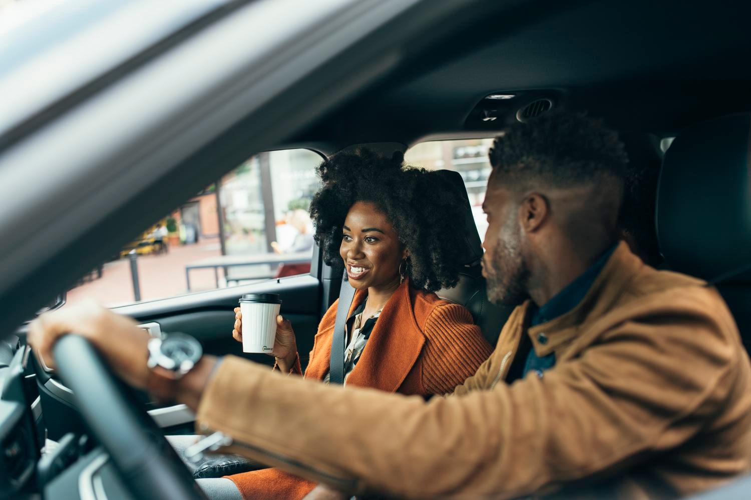 A man and woman chatting in a Ford vehicle. 
