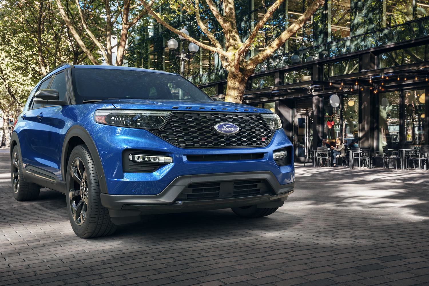 A blue Ford SUV on a city road. 