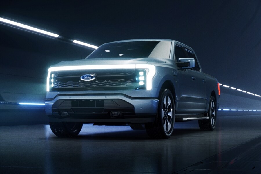 2022 Ford F-150 Lightning™ shown in Iced Blue Silver being driven in a tunnel