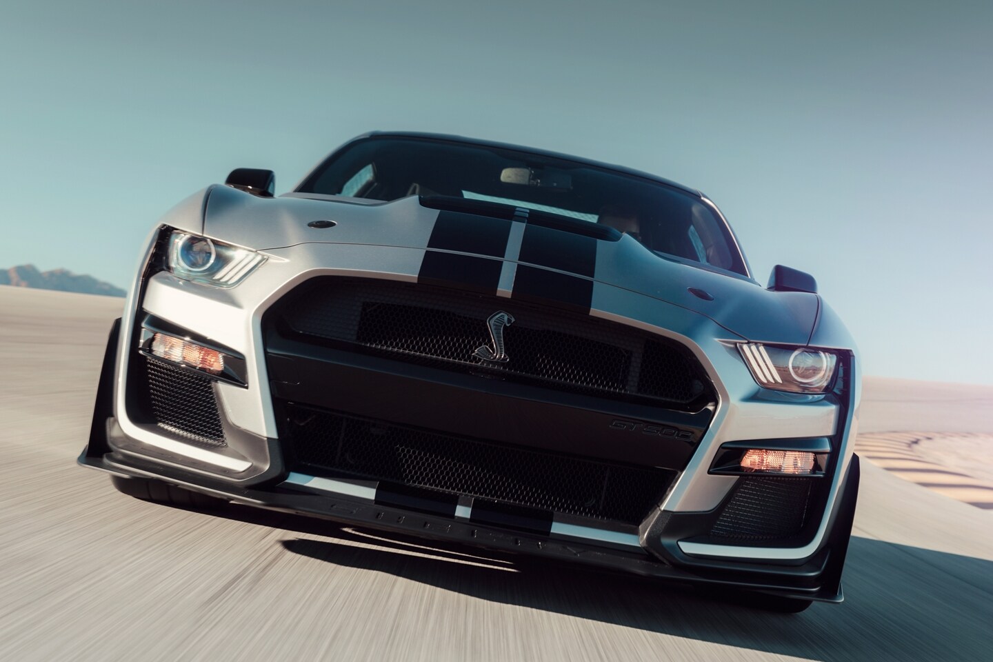 Front view of a 2021 Ford Mustang G T 500 being driven on a track