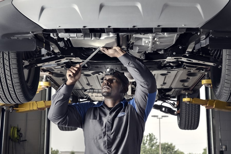 Ford Dealer Technician working on a vehicle at the dealership
