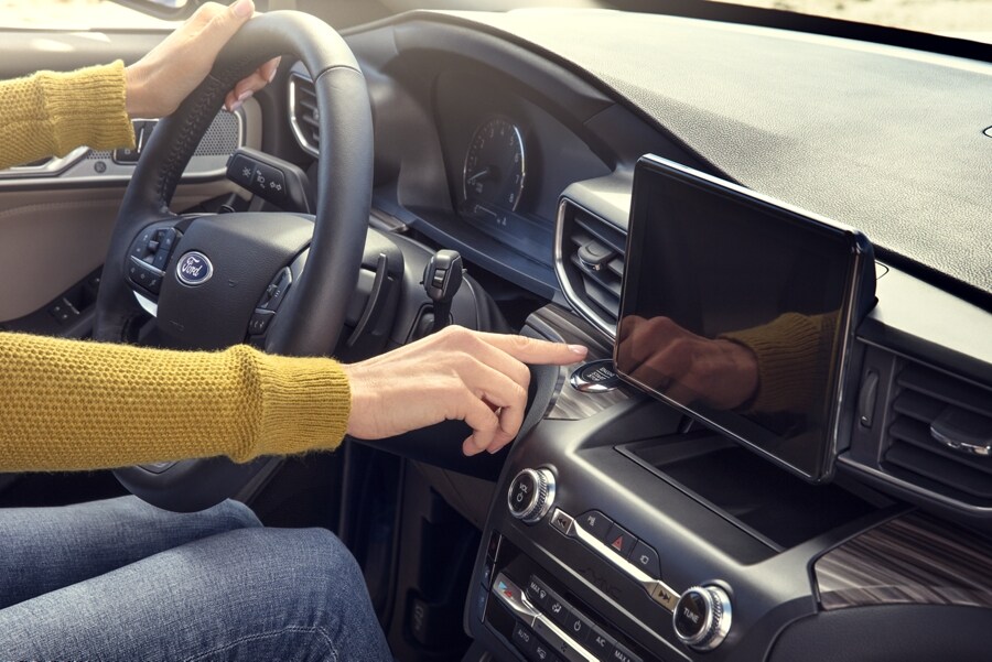 Person in a Ford vehicle using the radio