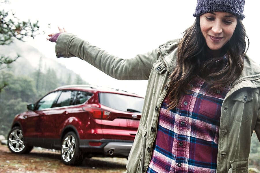 Person standing outside of a Ford SUV