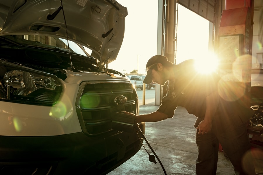 Service technician installing a charging cord on a 2023 Ford E-Transit™ van
