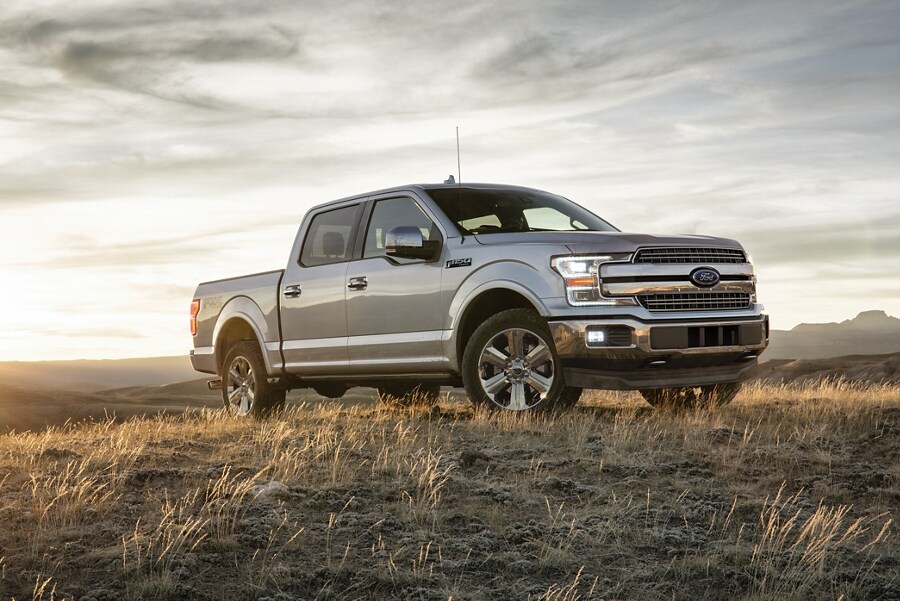 Front three quarter view of a Ford F 1 50 Lariat parked in a grassy field