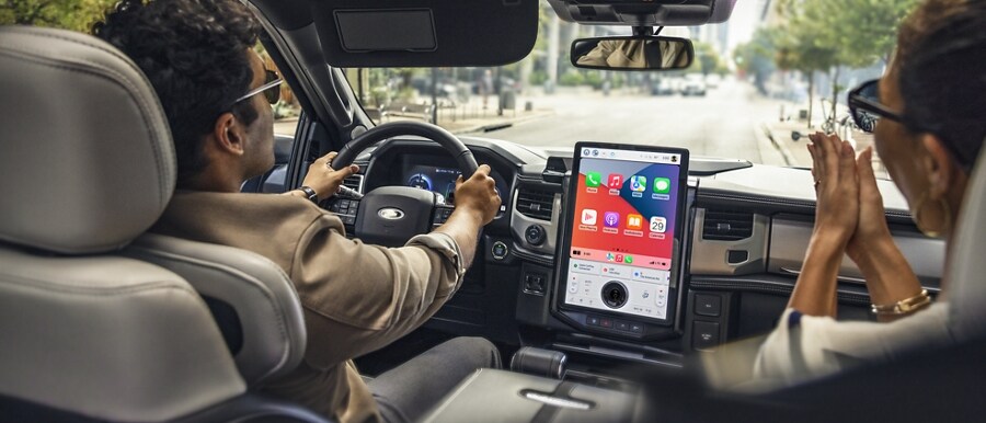Interior view of a couple driving in a 2023 Ford Mustang Mach-E®