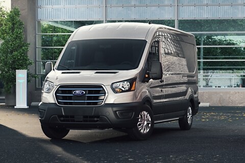 A 2023 Ford E-Transit™ parked outside of a business