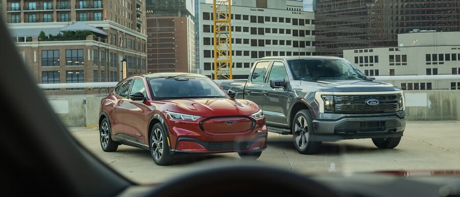 A 2023 Ford Mustang Mach-E® and 2023 Ford F-150® Lightning® being approached by another vehicle