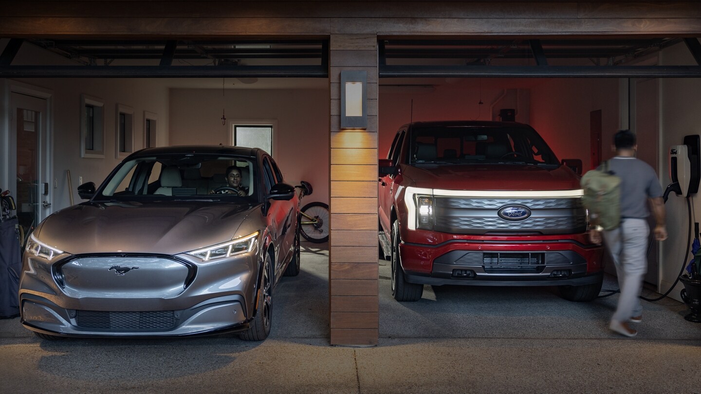 A 2023 Ford Mustang Mach-E and 2023 Ford F-150 Lightning parked side by side in a residential garage