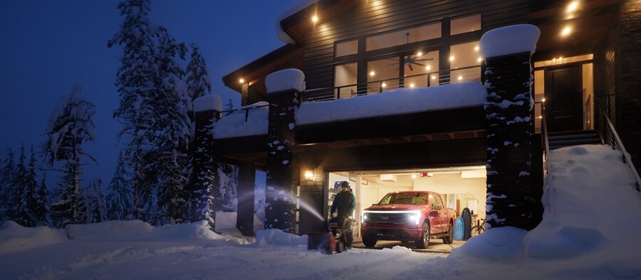 A 2023 Ford F-150 Lightning® seen charging in a garage at night