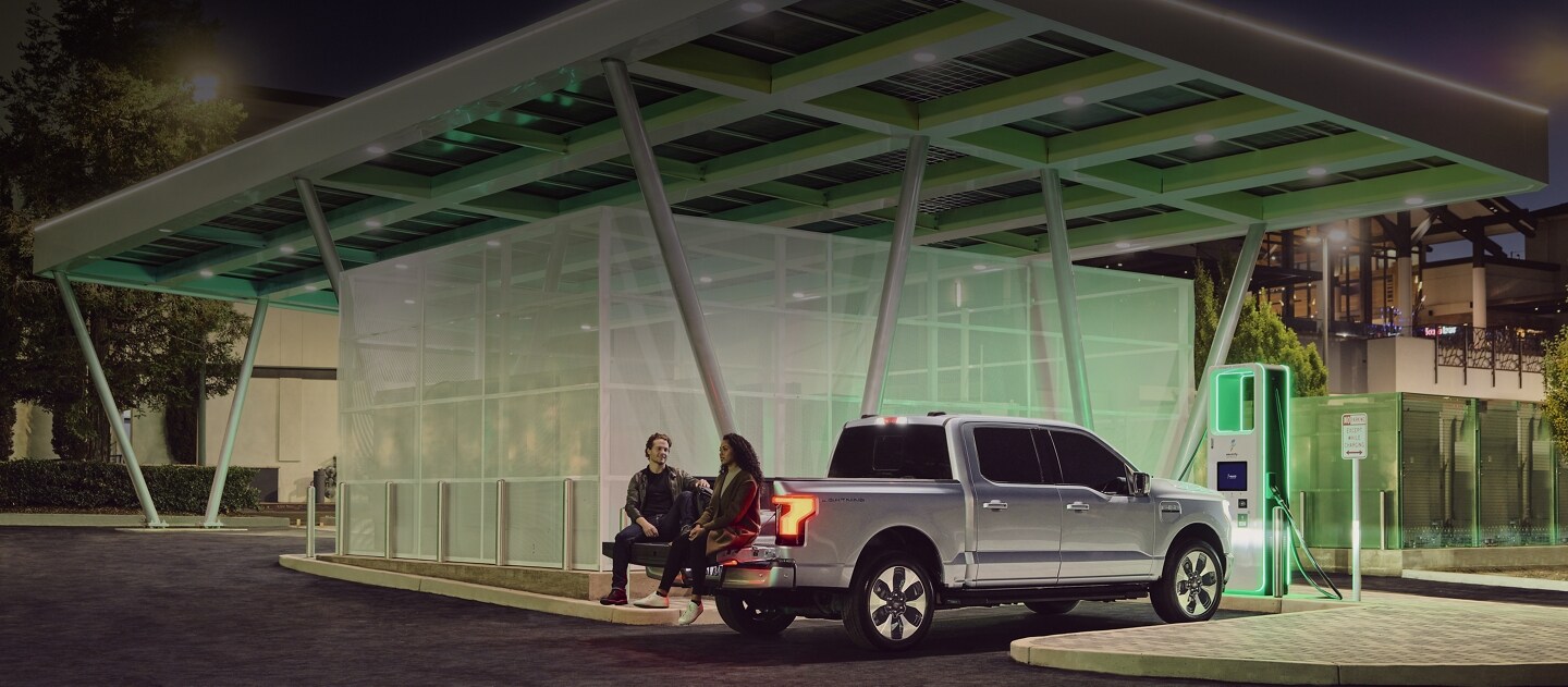 A 2023 Ford F-150® Lightning® charging at a public charging station