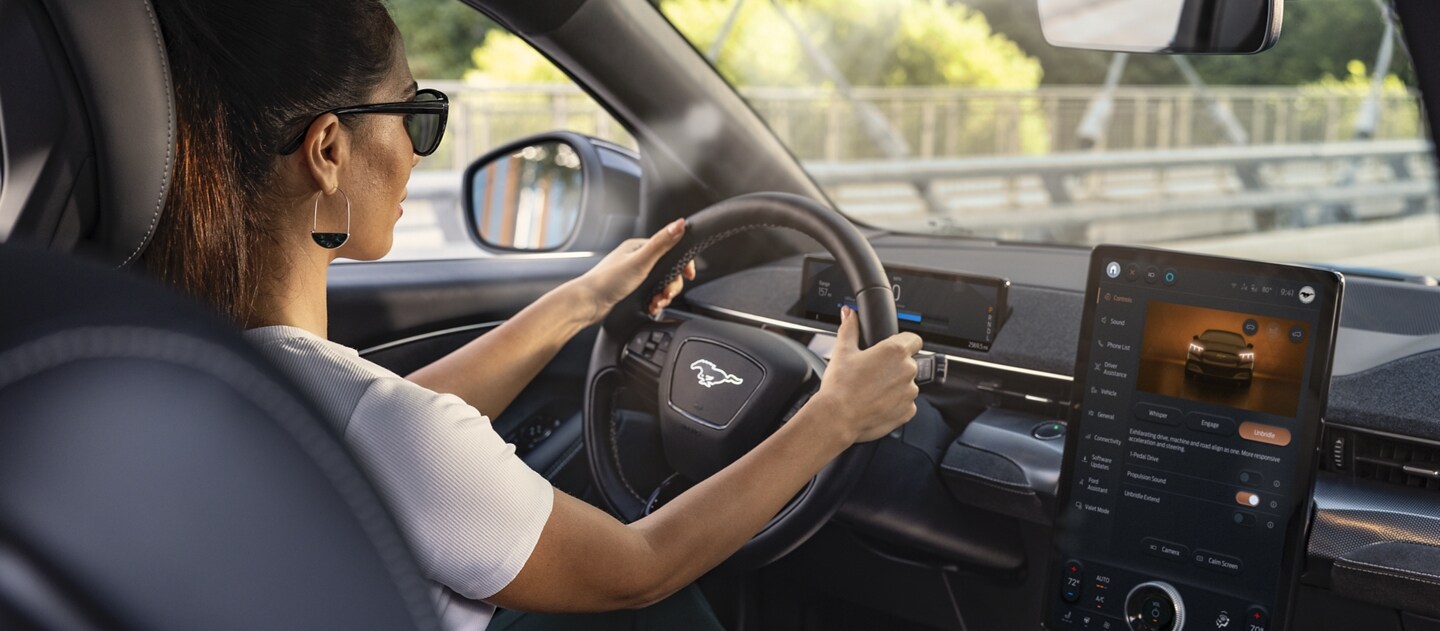 Interior view of a woman driving a Mustang® Mach-E®