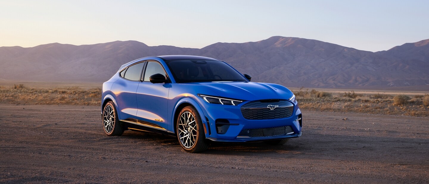 A 2023 Ford Mustang Mach-E® with a desert mountain range seen in the background