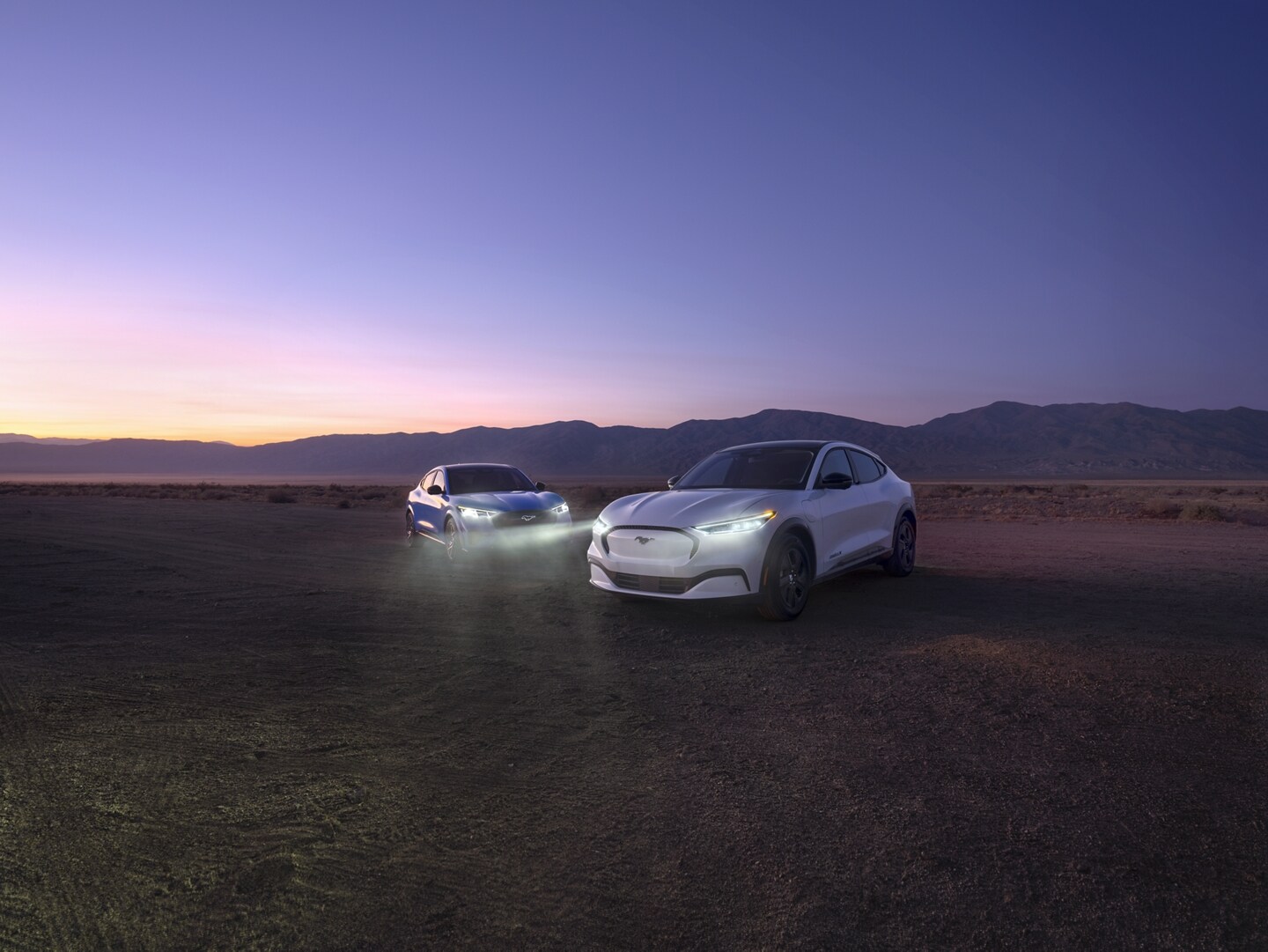 Two 2023 Ford Mustang Mach-E® SUVs in a twilight desert setting