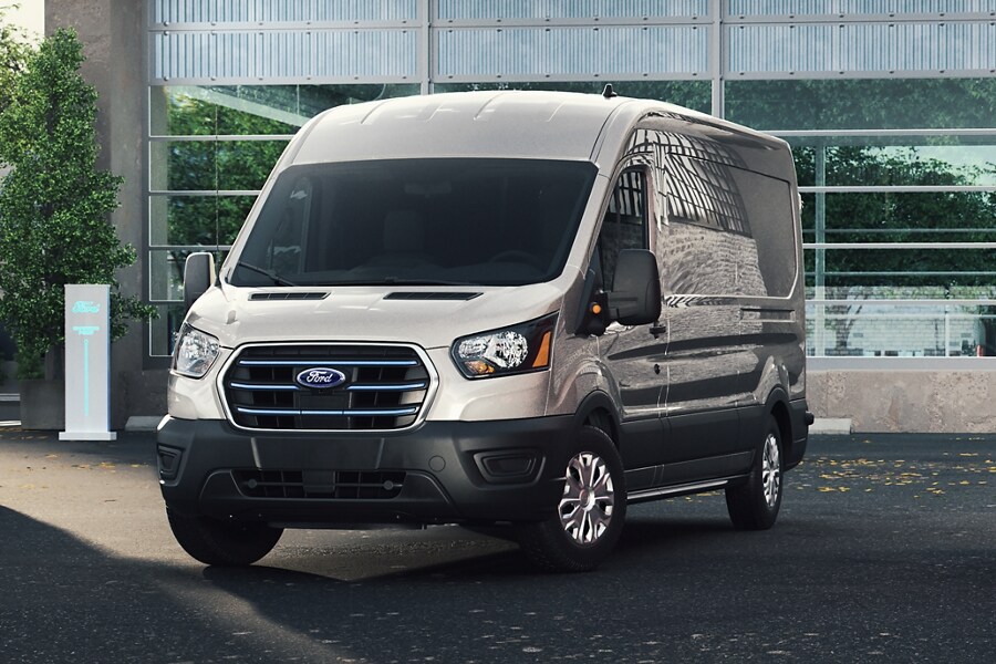 An E-Transit™ parked outside of a business