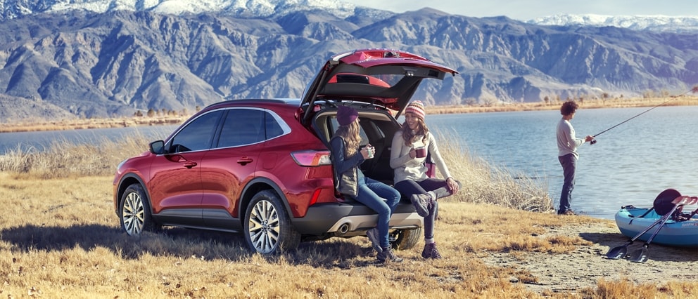 2020 Ford Escape Titanium in Rapid Red Metallic Tinted Clearcoat with an open liftgate parked by a lake