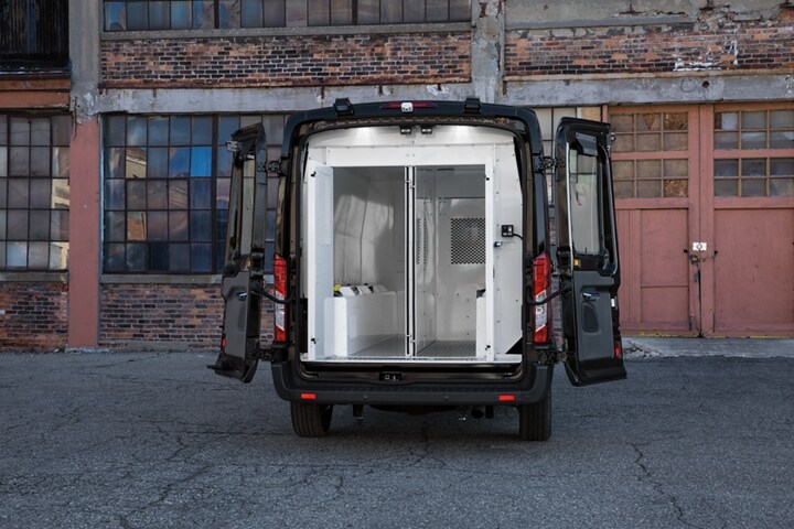 Open rear prisoner compartments in a twenty twenty ford transit prisoner transport vehicle 