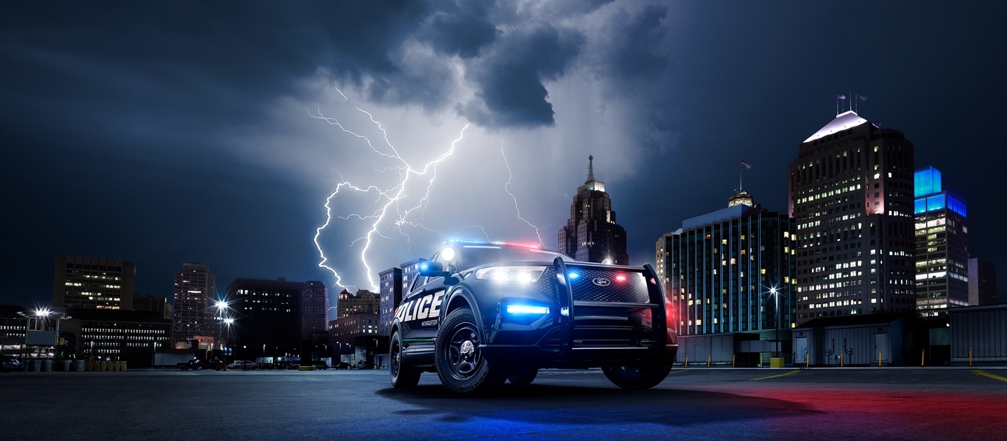 The ford police interceptor utility seen against a city skyline