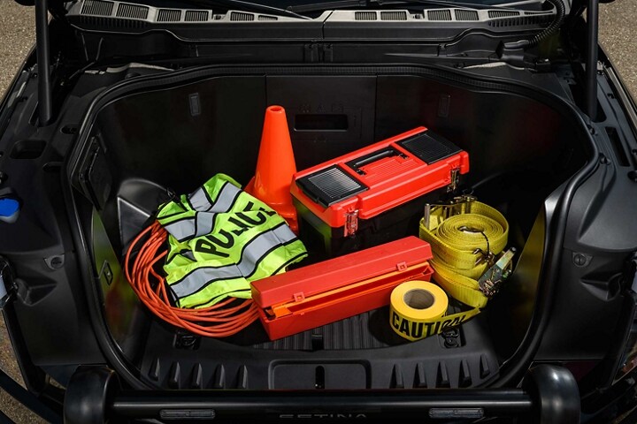 2023 Ford F-150®️ Lightning™️ Pro SSV frunk filled with law enforcement equipment like police vest, traffic cones, caution tapes and wires
