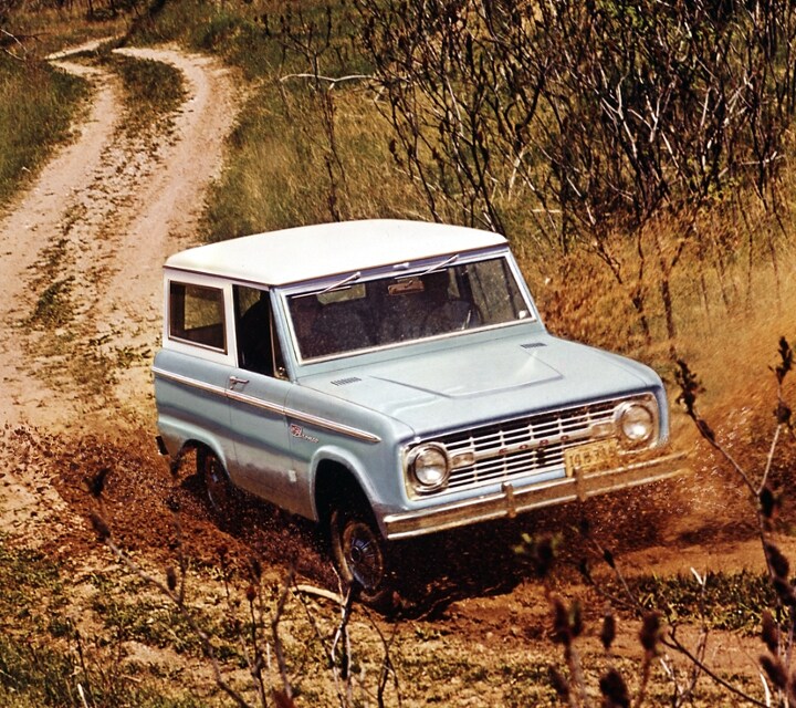 A 1967 Ford Sport Bronco Wagon being driven on a dusty trail