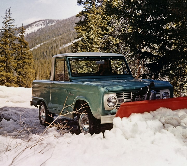 1967 Ford Bronco Pickup in Holly Green with a Wimbledon white roof and snowplow attachment