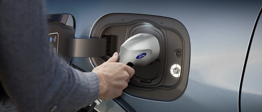 Man plugging a charger into a 2022 Ford Mustang Mach-E