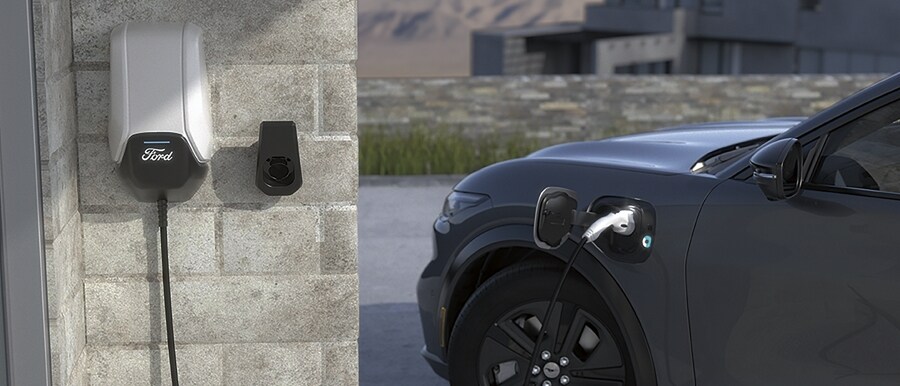 2022 Ford Mustang Mach-E charging outdoors next to a home