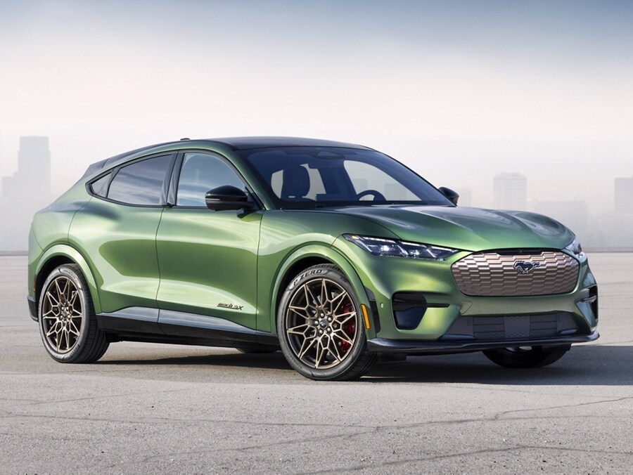 A green Ford Mustang Mach-E sits outside a city landscape