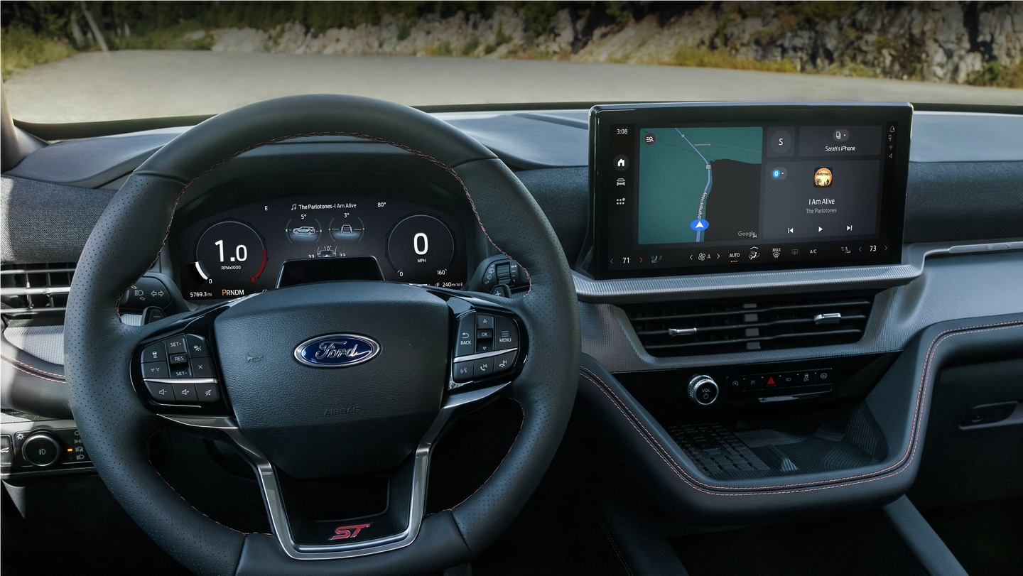 An interior, driver’s perspective of The Ford Digital Experience present on the instrument cluster and center screen.