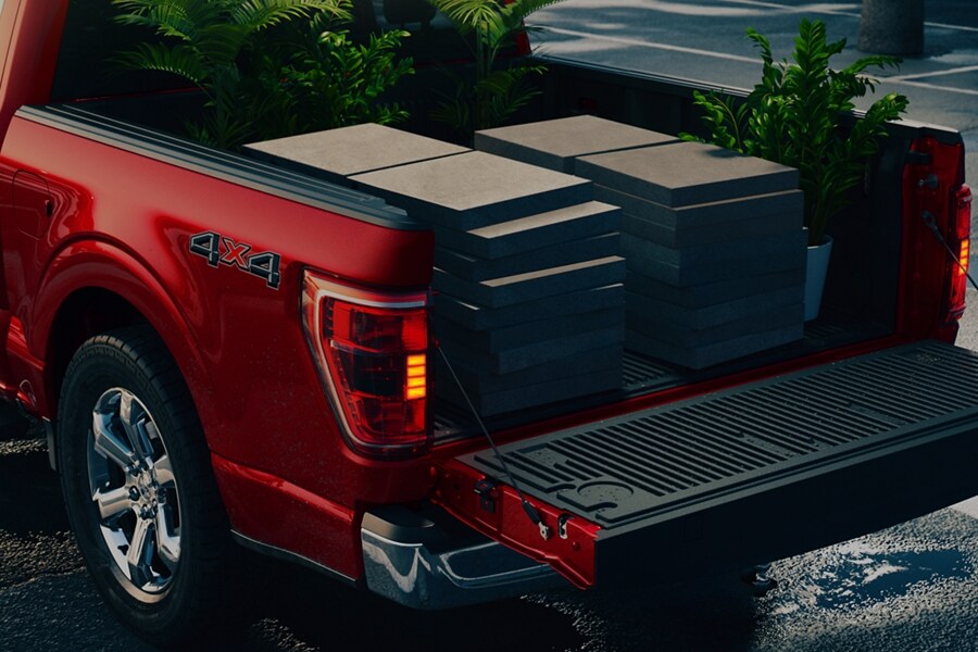 View of an F-150® tailgate folded down and large concrete patio pavers in the bed of the truck