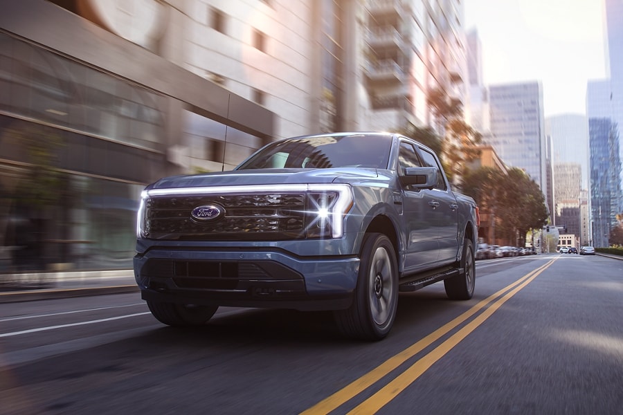 2023 F-150® Limited in Velocity Blue being driven in the city
