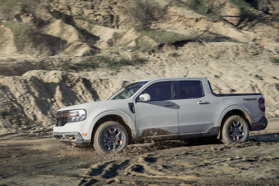 A 2023 Ford Maverick® Tremor® being driven over sandy desert terrain