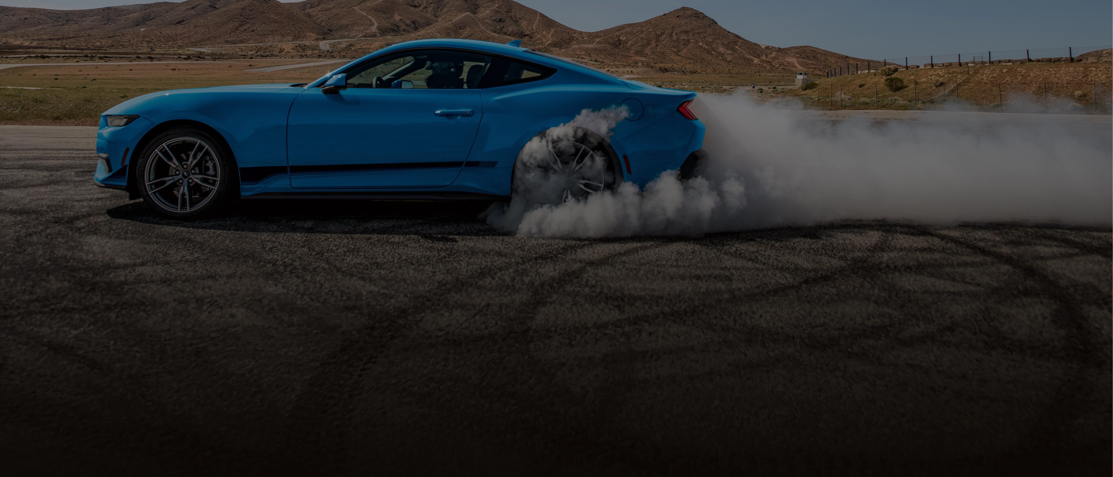 24/25MY EcoBoost Premium in Grabber Blue with rear wheel making smoke and tearing up road