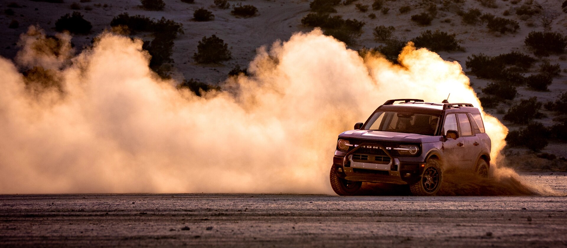 A 2025 Ford Bronco Sport® SUV with drifting on a dirt road