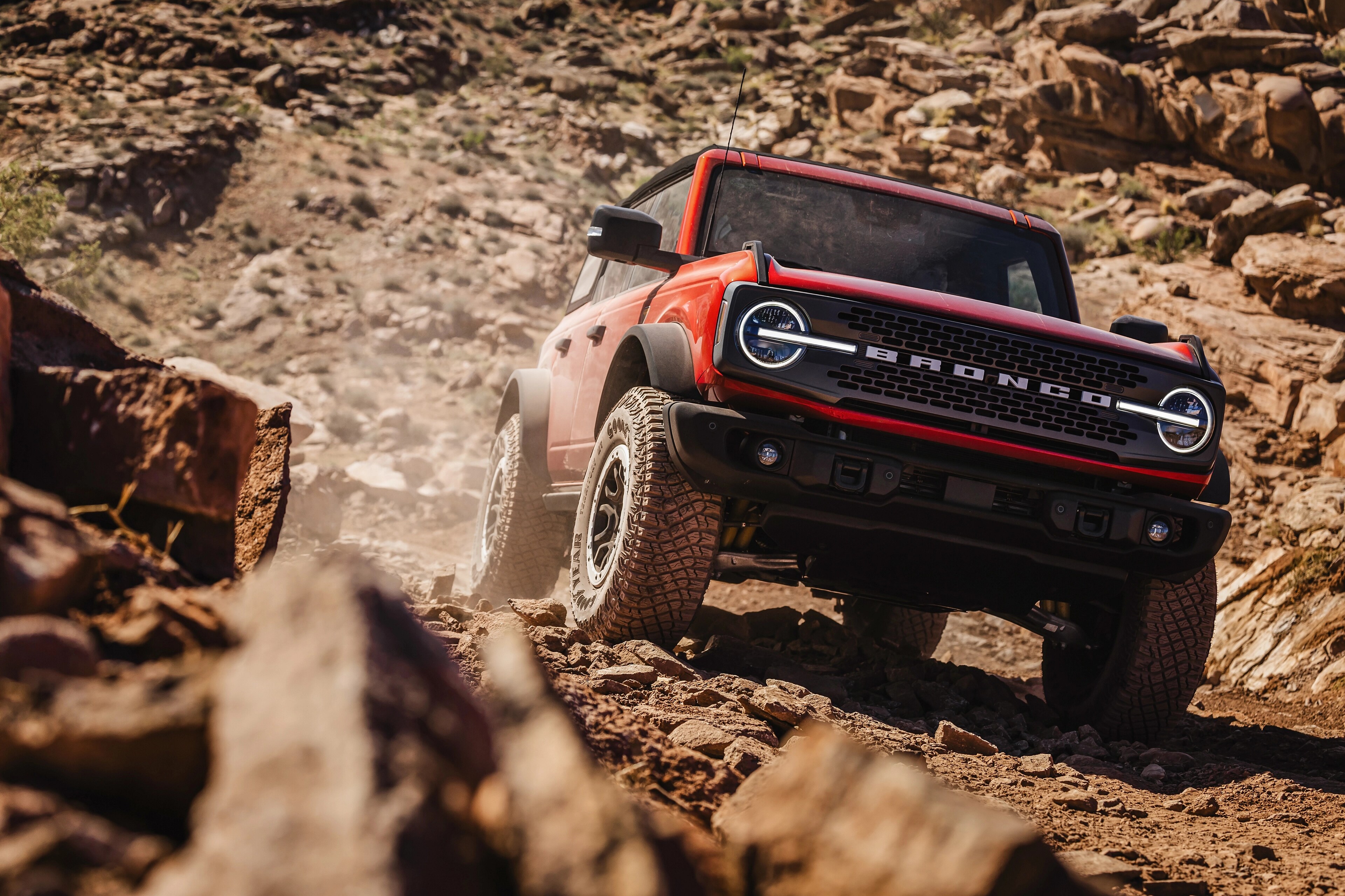 A Bronco® SUV is being driven up a steep, rocky incline