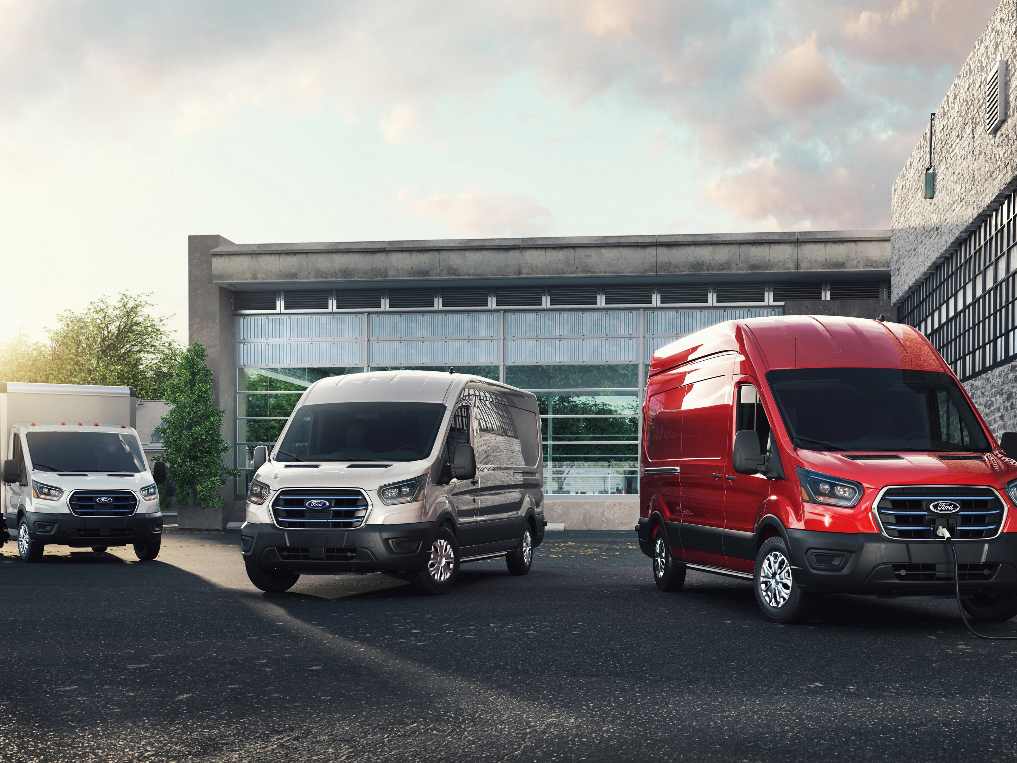 Ford E-Transit™ models parked in front of an office building