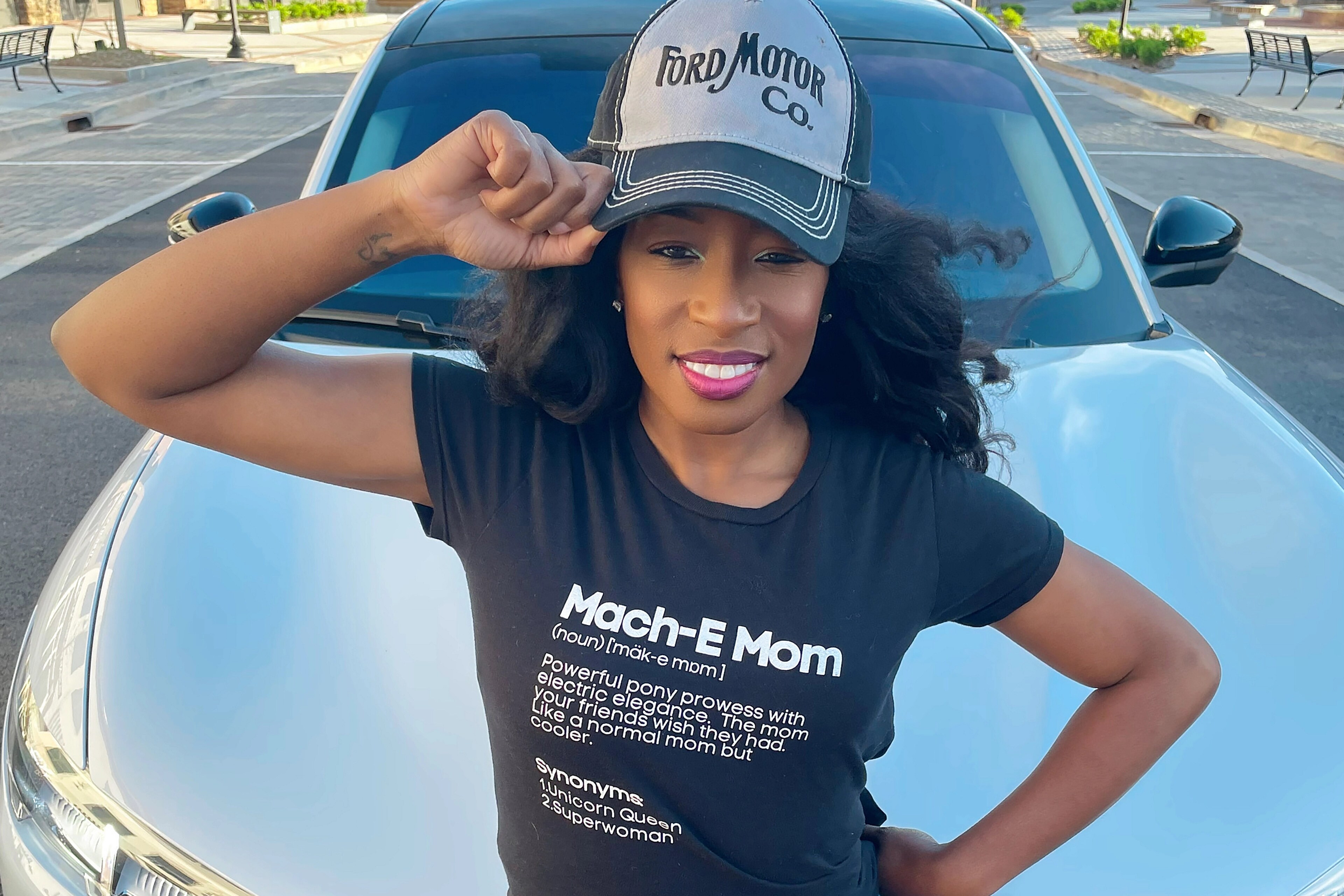 Woman standing in front of her Ford Mustang Mach-E