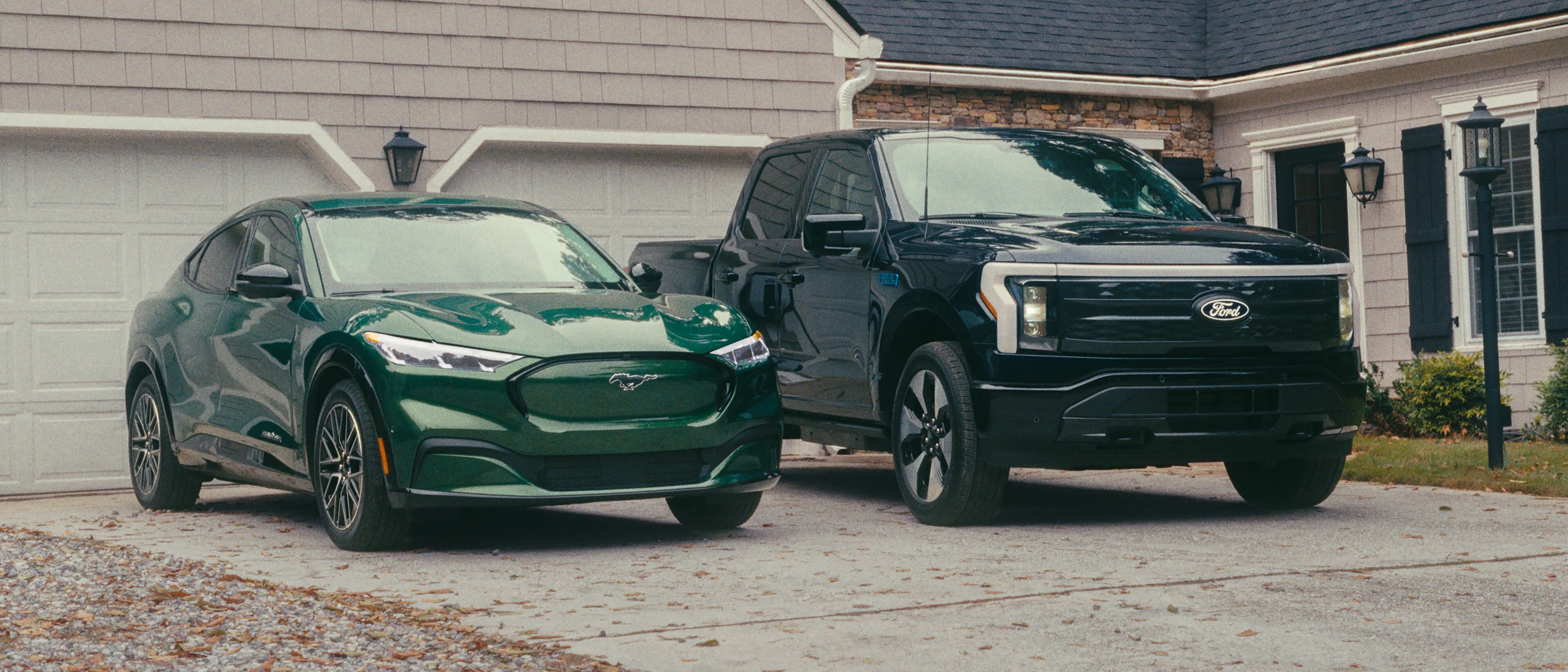 A 2024 Ford Mustang Mach-E and a 2024 Ford F-150 Lightning parked in a driveway