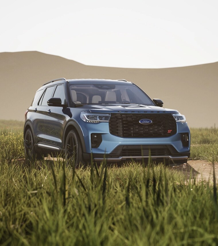 Blue 2025 Ford Explorer St parked in grassy field