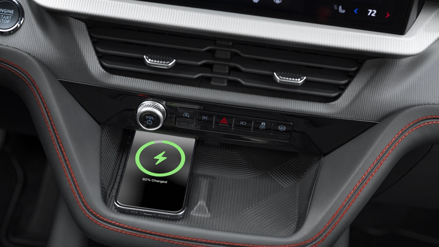 A smart phone charges on a wireless charging pad