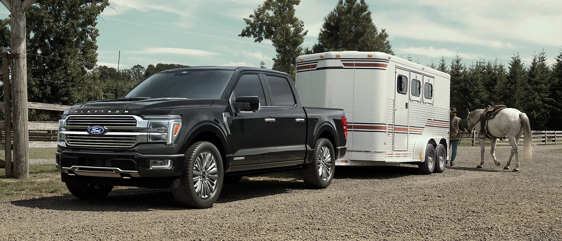 2026 Ford F-150® XLT pickup in Agate Black hitched to horse trailer
