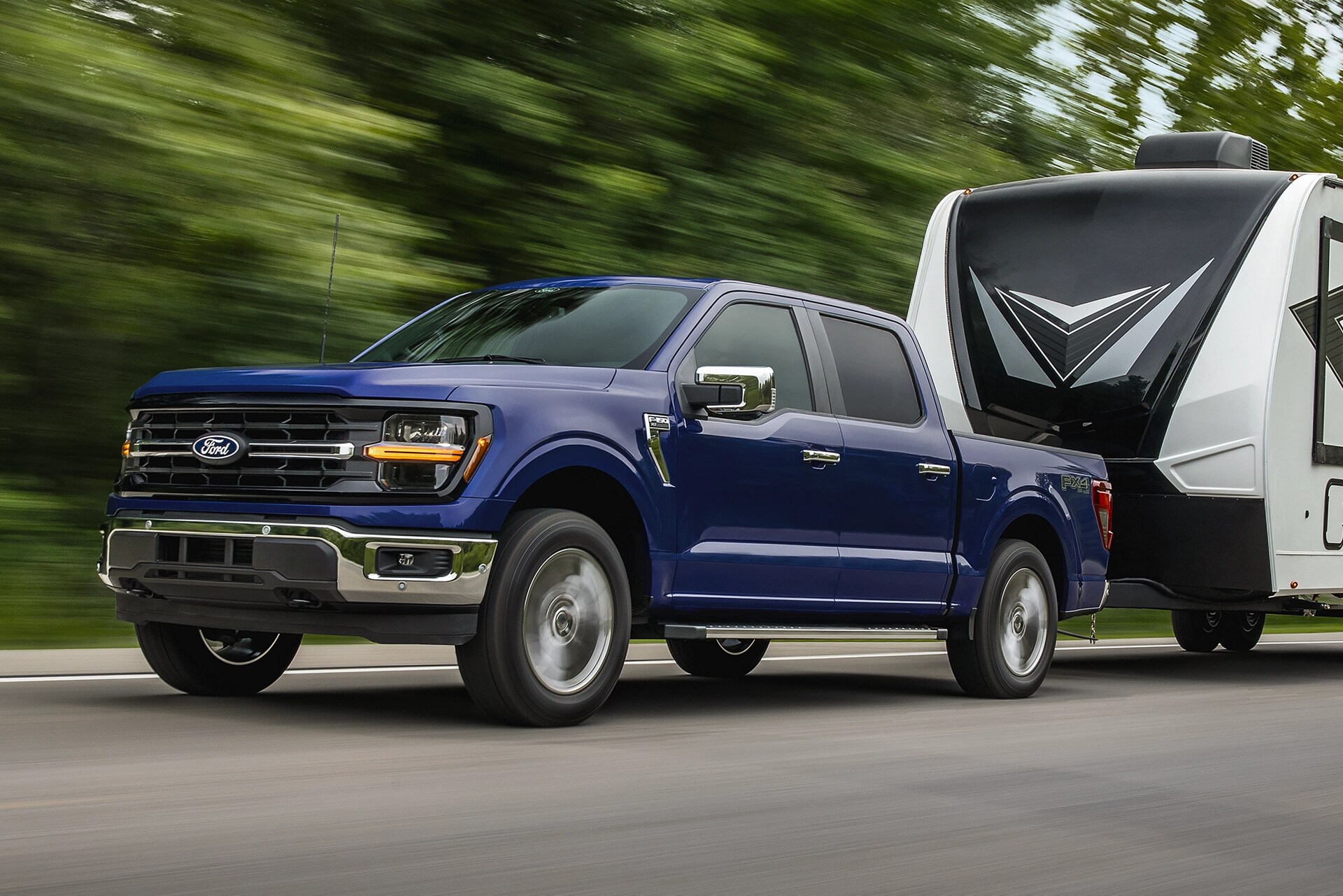2026 Ford F-150® XL pickup in Atlas Blue Metallic pulling a camper